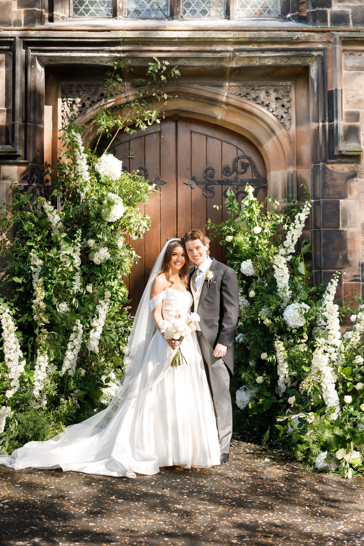 Wedding ceremony with floral pedestals and aisle styling