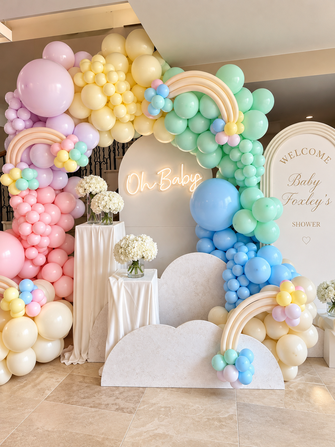 Pastel baby shower styling with balloon installations and welcome display