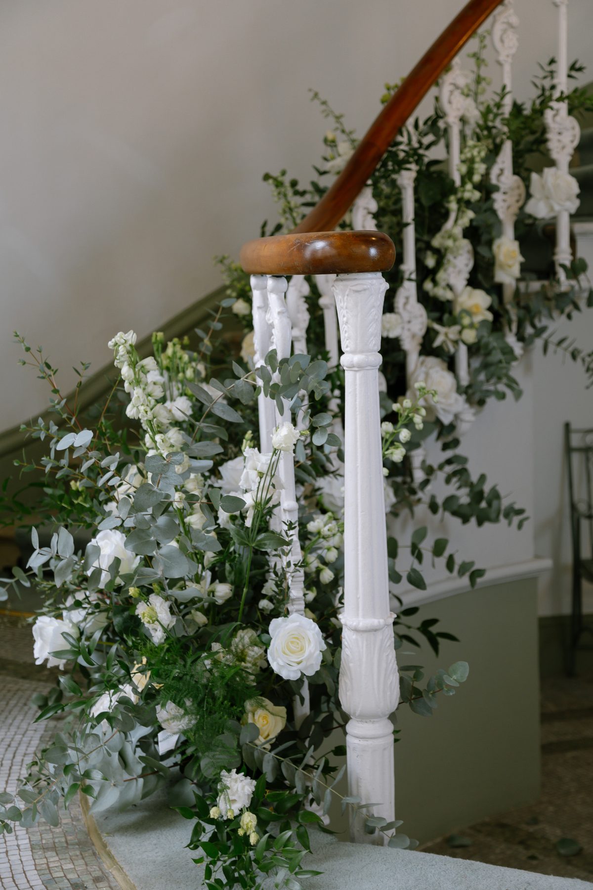Statement floral styling around a venue staircase